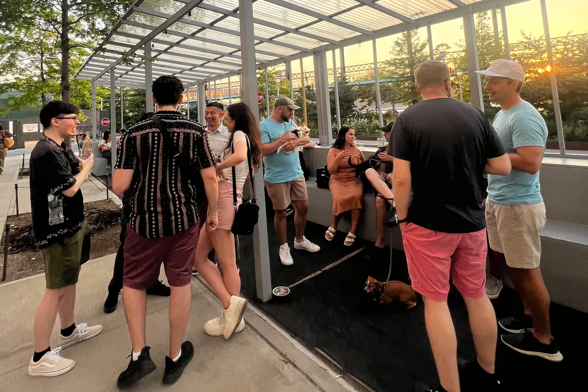 Conversations at a Craft Club meetup under a pergola at golden hour