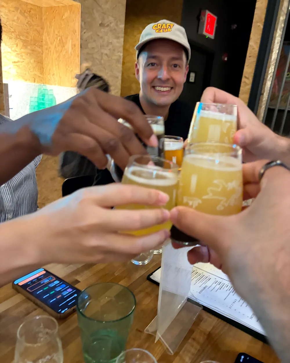 A Rounds table raising beer tasters together at an NYC brewery